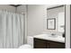 Well-lit bathroom with a shower featuring neutral tile and a modern vanity with a white countertop at 313 Marion Rd, Dorchester, SC 29437