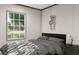 Comfortable bedroom with a large window offering natural light and a cozy gray comforter set at 313 Marion Rd, Dorchester, SC 29437