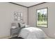 Comfortable bedroom featuring a twin bed, charming artwork, a bedside table and ample light from a large window at 313 Marion Rd, Dorchester, SC 29437