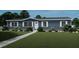 Charming single-story home with blue siding, white trim, a well-manicured lawn, and a paved walkway at 313 Marion Rd, Dorchester, SC 29437