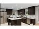 Spacious kitchen with dark wood cabinets, stainless steel appliances, and an island with seating at 313 Marion Rd, Dorchester, SC 29437