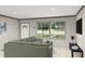 Cozy living room featuring a comfortable gray sofa, large windows, and modern decor at 313 Marion Rd, Dorchester, SC 29437