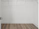Empty walk-in closet with a hanging rack and light hardwood floors at 3170 Vanessa Lynne Ln, Johns Island, SC 29455