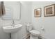 Clean powder room featuring a pedestal sink, toilet, and decorative artwork at 3170 Vanessa Lynne Ln, Johns Island, SC 29455