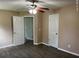 Bedroom with neutral walls and wood-look floors featuring multiple white doors for closet and room access at 352 Oxford Rd, Ladson, SC 29456
