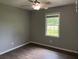 Bedroom features a ceiling fan and a window providing natural light, complemented by wood-look flooring at 352 Oxford Rd, Ladson, SC 29456