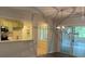 Open dining area with modern lighting and a view into the kitchen, leading to a bright sunroom at 352 Oxford Rd, Ladson, SC 29456