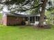 Back of the house with a screened-in porch and large tree at 352 Oxford Rd, Ladson, SC 29456