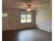 Bright living room featuring hardwood floors, a ceiling fan, and a large window for plenty of natural light at 352 Oxford Rd, Ladson, SC 29456