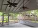 Screened patio with ceiling fans overlooking fenced backyard at 352 Oxford Rd, Ladson, SC 29456