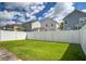 Backyard with manicured lawn and a white fence, offering privacy and space for outdoor activities at 3903 Poplar Grove Pl, Summerville, SC 29483