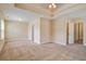Open carpeted bedroom featuring tray ceilings and several entry doors at 3903 Poplar Grove Pl, Summerville, SC 29483