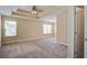 Well-lit bedroom with tray ceiling, neutral carpet, and natural light from large windows at 3903 Poplar Grove Pl, Summerville, SC 29483