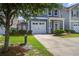 Charming two-story home with a well-manicured lawn, driveway, and attached garage at 3903 Poplar Grove Pl, Summerville, SC 29483