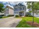 Charming two-story home featuring a well-manicured lawn, driveway, and attached garage at 3903 Poplar Grove Pl, Summerville, SC 29483