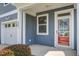 Inviting front porch featuring a red door and an attached garage at 3903 Poplar Grove Pl, Summerville, SC 29483