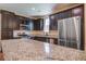 Modern kitchen with granite countertops, stainless steel appliances, and dark wood cabinets at 3903 Poplar Grove Pl, Summerville, SC 29483
