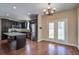 Elegant kitchen featuring dark wood cabinets, stainless steel appliances, and a chandelier at 3903 Poplar Grove Pl, Summerville, SC 29483