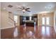 Spacious living room with wood floors and stairs, that opens into a kitchen with stainless appliances at 3903 Poplar Grove Pl, Summerville, SC 29483
