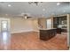 Open concept living room with wood floors and stairs, opening to a kitchen with island at 3903 Poplar Grove Pl, Summerville, SC 29483