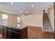 Spacious living room with hardwood floors, granite island, and staircase to the second floor at 3903 Poplar Grove Pl, Summerville, SC 29483