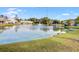 Scenic pond view featuring a fountain and surrounding community buildings at 3903 Poplar Grove Pl, Summerville, SC 29483