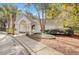 Exterior view of community pool house featuring a gated entrance and lush landscaping at 3903 Poplar Grove Pl, Summerville, SC 29483