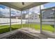 View from a screened-in porch overlooking the fenced backyard and neighboring homes at 3903 Poplar Grove Pl, Summerville, SC 29483