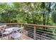 Balcony with a round table and lush green trees in the background at 4030 Babbitt St, Charleston, SC 29414