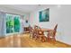 Dining room with light wood floors, a dining table, and a sliding door to a balcony at 4030 Babbitt St, Charleston, SC 29414