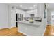 Open kitchen with white cabinets, stainless steel appliances, and a breakfast bar, perfect for casual dining and entertaining at 4030 Babbitt St, Charleston, SC 29414