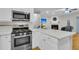 Well-equipped kitchen with stainless steel appliances, a gas range, and an open view to the living room fireplace at 4030 Babbitt St, Charleston, SC 29414