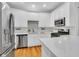 Modern kitchen with stainless steel appliances, white cabinets, and quartz countertops, creating a sleek and functional space at 4030 Babbitt St, Charleston, SC 29414