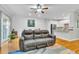 Open living area with a comfortable couch, hardwood floors, and seamless access to the kitchen and dining spaces at 4030 Babbitt St, Charleston, SC 29414