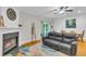 Bright living room with a fireplace, hardwood floors, and access to the outdoors, creating a relaxing atmosphere at 4030 Babbitt St, Charleston, SC 29414