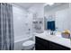 Bright bathroom showcasing a shower-tub combo, vanity with black cabinet, and decorative wall accents at 412 Grand Palm Ln, Summerville, SC 29485