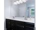 Bathroom featuring a double sink vanity with black cabinetry, a large mirror, and modern fixtures at 412 Grand Palm Ln, Summerville, SC 29485