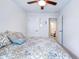 Bright bedroom with carpet, a bed with patterned bedding, and a doorway that leads to an adjacent bathroom at 412 Grand Palm Ln, Summerville, SC 29485