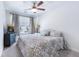 Comfortable carpeted bedroom with ceiling fan, curtained window, and a queen-sized bed with decorative pillows at 412 Grand Palm Ln, Summerville, SC 29485