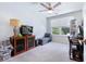 Bedroom with neutral carpet, a ceiling fan, a TV, and a built-in bookcase by a bright window at 412 Grand Palm Ln, Summerville, SC 29485