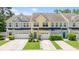Charming townhomes featuring colorful facades, attached garages, and well-manicured landscaping at 412 Grand Palm Ln, Summerville, SC 29485