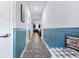 Long hallway with wood-look floors and wainscoting connecting living spaces at 412 Grand Palm Ln, Summerville, SC 29485