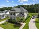 An aerial view showcases a gray two-story home with manicured lawns and a long driveway leading to the property at 4140 Home Town Ln, Ravenel, SC 29470