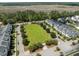 Aerial view of community with a central green space with marsh in the distance at 4140 Home Town Ln, Ravenel, SC 29470
