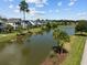 Scenic view of community pond and homes with lush landscaping at 4140 Home Town Ln, Ravenel, SC 29470