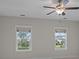 A light-filled bedroom features two large windows and natural light at 4140 Home Town Ln, Ravenel, SC 29470