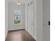 Bright entryway featuring hardwood floors, a large window, and a white front door, creating a welcoming ambiance at 4140 Home Town Ln, Ravenel, SC 29470