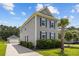 A gray two-story home with a detached garage, complemented by lush landscaping and a well-maintained lawn at 4140 Home Town Ln, Ravenel, SC 29470