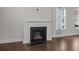 Close-up of a traditional fireplace with a black surround, white mantel, and dark hardwood floors in a living space at 4140 Home Town Ln, Ravenel, SC 29470