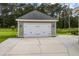 Spacious two car garage with carriage doors, gray lap siding and concrete driveway at 4140 Home Town Ln, Ravenel, SC 29470